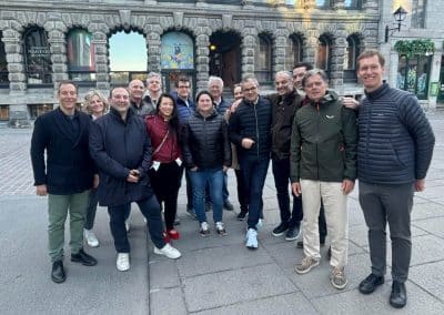 Group of people posing outdoors together.